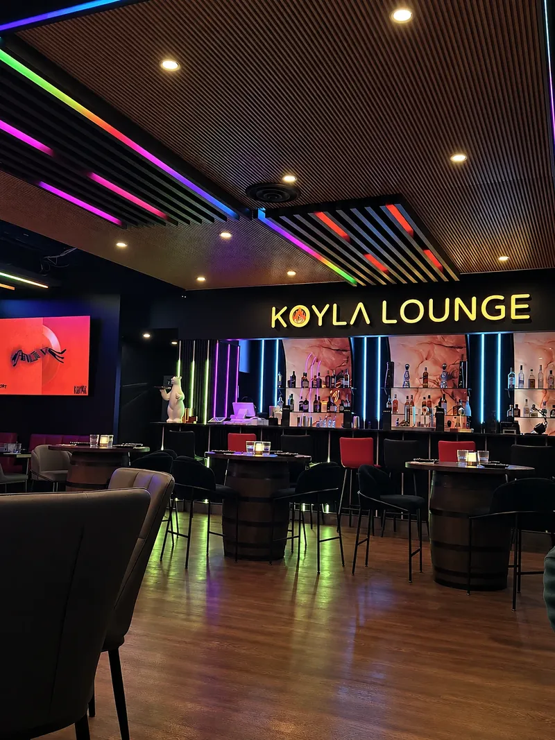 The lounge at night under the KOYLA LOUNGE sign